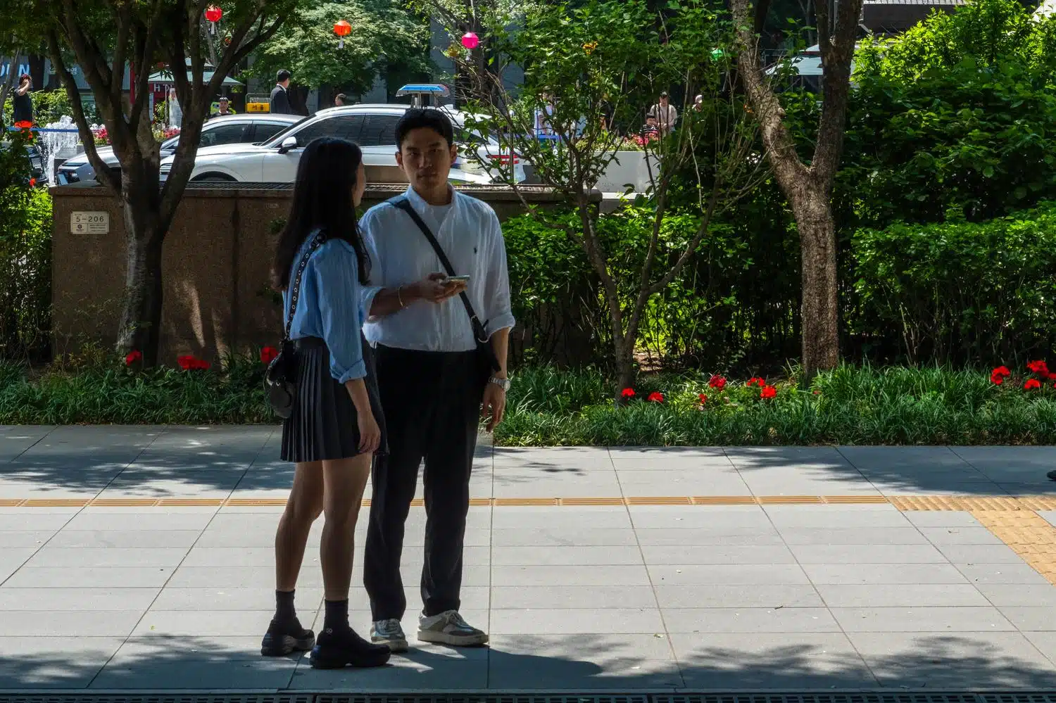 couple-gwanghwamun-seoul A couple stands on a street in Seoul.