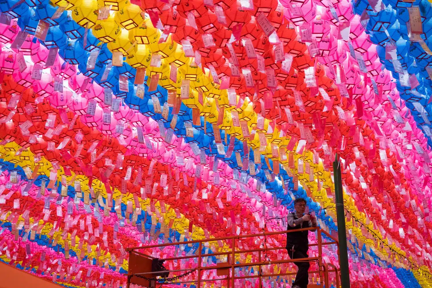 jogyesa-lanterns-2026-Seoul A worker installs colorful lanterns in Jogyesa buddhist temple in Seoul.