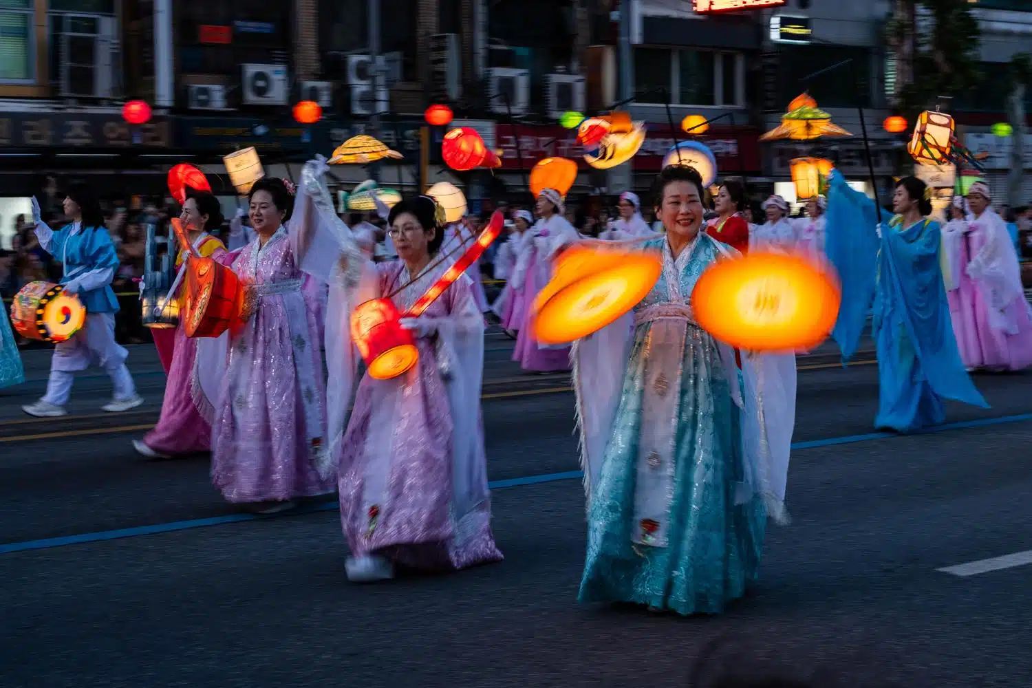 seoul-lotus-lantern-festival-2026-6 People parade through the streets of Seoul at night carrying lanterns during the Lotus Lantern Festival, which marks Buddha's birthday in May.