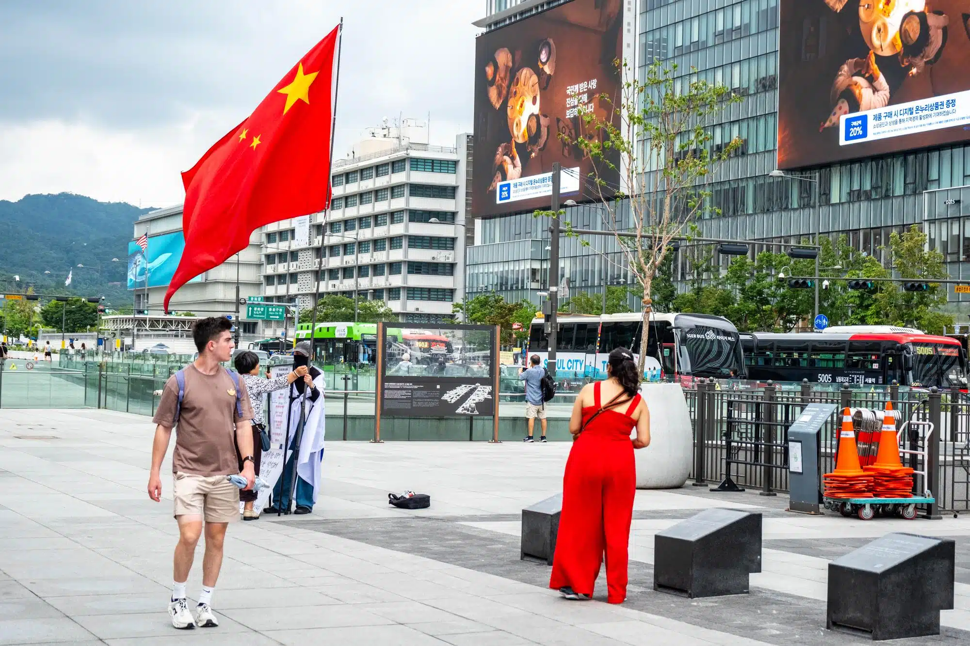 seoul-streets-july-2026-15 A protester carries a Chinese flag in Seoul.