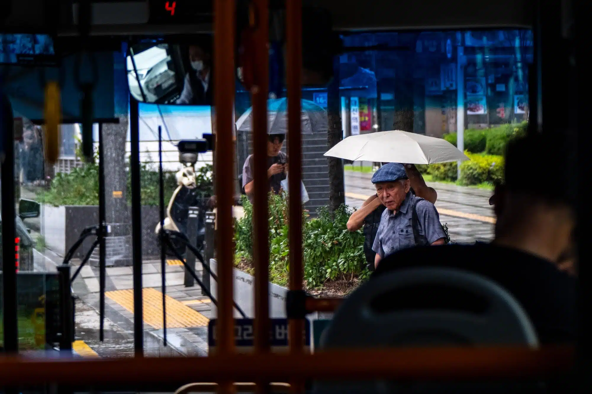 seoul-streets-july-2026-22 View from inside a bus in Seoul under heavy monsoon rain in July 2026.